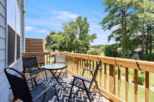a balcony with two chairs and a table on it at Luxe King 4 BR Townhouse Mins to Dwtn Durham in Durham