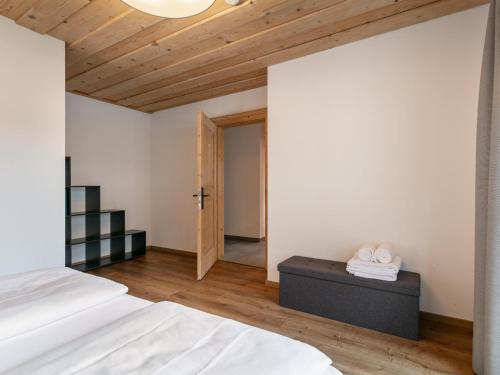 a bedroom with a bed and a wooden ceiling at Appartement Dörler in Kirchberg in Tirol