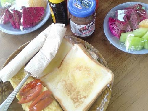 a plate of food with a sandwich on a table at Neo Robiu & Ijen Tour in Banyuwangi