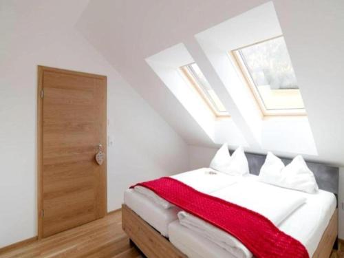 a bedroom with a bed with a red blanket at Bösenstein in Hohentauern