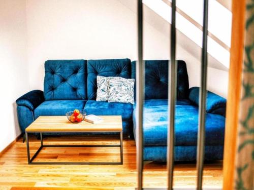 a blue couch in a living room with a table at Bösenstein in Hohentauern