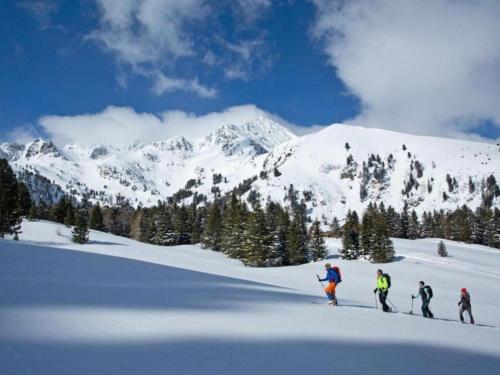 three people are skiing on a snow covered mountain at Bösenstein in Hohentauern