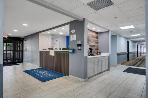 an office lobby with a reception desk and a counter at Baymont by Wyndham La Crosse/Onalaska in Onalaska