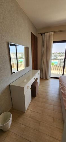 a bedroom with a white desk and a mirror at Azha Sokhna private villa in Ain Sokhna