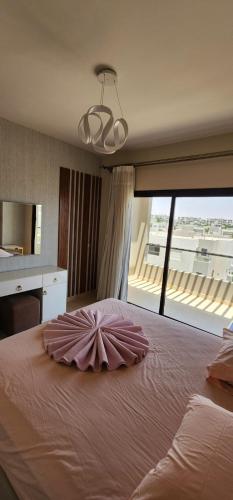 a large bed with a dress on top of it at Azha Sokhna private villa in Ain Sokhna