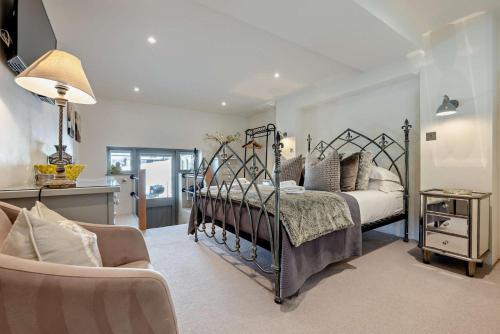 a bedroom with four beds and a living room at Roundhouse Mill - St Issey in Saint Issey