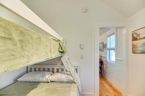 a bedroom with a bunk bed with a ladder at Walk to Main St Osterville Village Gem with Patio in Osterville