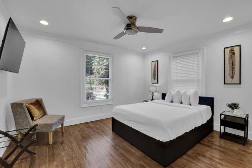 a white bedroom with a bed and a chair at Stunning 6BR Buckhead OasisPrivate BathEachRoom in Atlanta