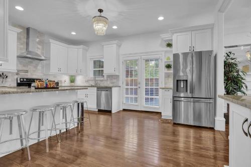 a kitchen with white cabinets and stainless steel appliances at Stunning 6BR Buckhead OasisPrivate BathEachRoom in Atlanta