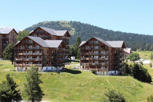 a group of apartment buildings on a hill with trees at Les Chalets De Superd Ancolie - APPARTEMENT DANS CHALET DE 30 LOGEMENTS EXPO SUD MAE-8854 in Le Dévoluy