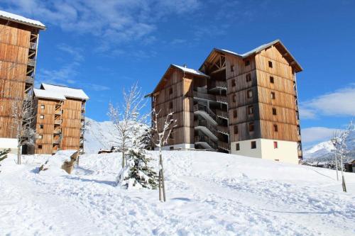 a building on top of a snow covered hill at Les Chalets De Superd Bleuet - 2 Pièces pour 4 Personnes MAE-8884 in Le Dévoluy