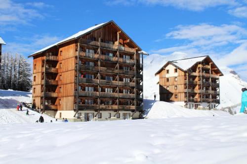 a large building in the snow next to two buildings at Les Chalets De Superd Bleuet - 2 Pièces pour 4 Personnes MAE-8884 in Le Dévoluy