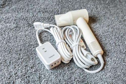 a charger and a cell phone sitting on the floor at Hiro Yanaka hotel TT0421 in Tokyo