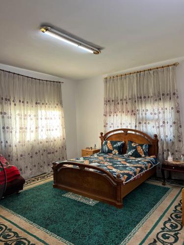 a bedroom with a bed in a room with curtains at بيت جرش - Jerash House in Jerash