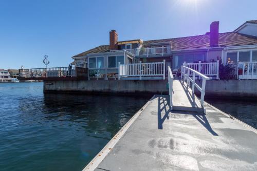 a row of houses on a dock next to the water at Harbor View in Oxnard