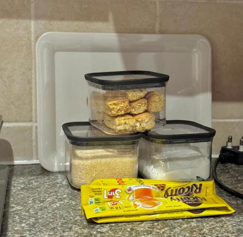 a container of food and a bag of food in a refrigerator at The olive stay at Edwardian unit F7 in Port Edward