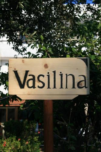 a sign that says vesta on a wooden pole at Vasilina in Faliraki