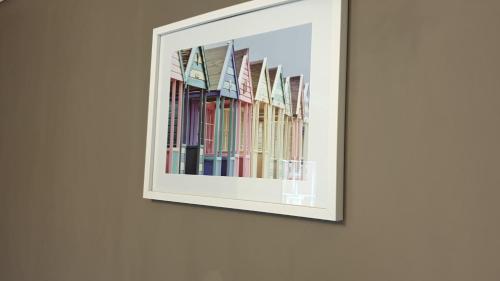 a framed picture of a row of books on a wall at The Grapes Pub in Southampton