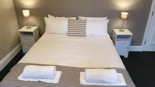 a bedroom with a large bed with two night stands at The Grapes Pub in Southampton