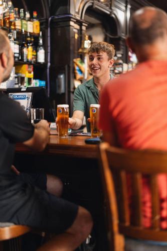 a man sitting at a table in a bar at The Grapes Pub in Southampton