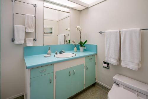 a bathroom with a blue sink and a mirror at Family Tides in Ventura