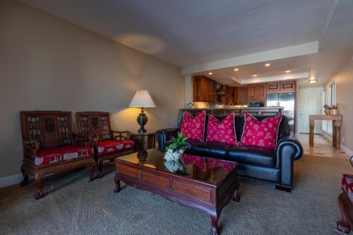 a living room with a black couch and red pillows at Harbor View in Oxnard
