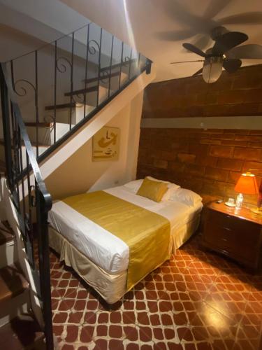 a bedroom with a bed and a stair case at Hostal Fuente Castalia, B y B in León