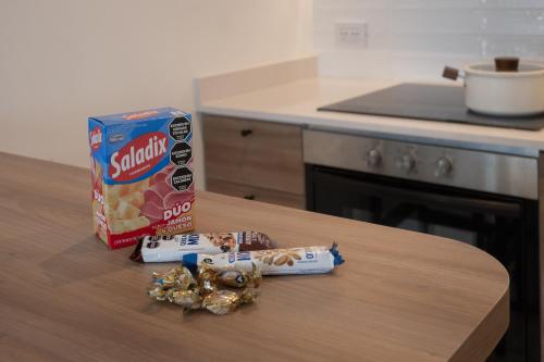 a box of candy on a table in a kitchen at Departamento Premium en Puerto Norte con vista al río in Rosario