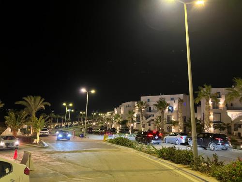 a parking lot at night with cars parked at Mountain View Resort Chalet in Ras El Hekma in Ras Elhekma