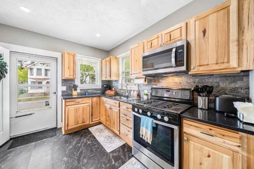 a kitchen with wooden cabinets and a stove top oven at Updated Lakewood Retreat! in Birds Nest
