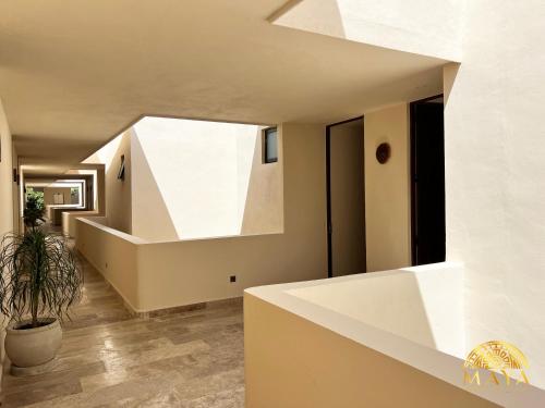 a staircase in a house with a round window at Peregrina Tulum 302C 1-Bedroom Luxury Condo in Tulum