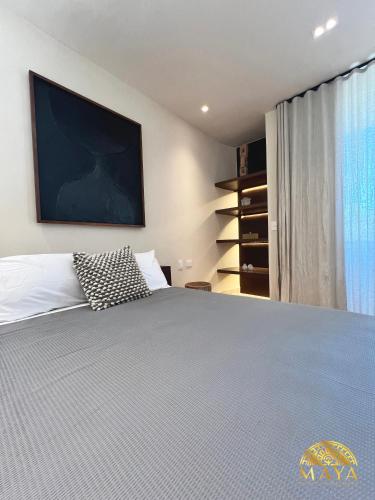 a bedroom with a large bed and a window at Peregrina Tulum 302C 1-Bedroom Luxury Condo in Tulum
