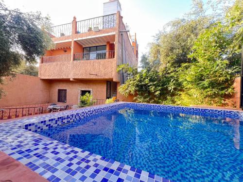 a swimming pool in front of a house at Beyond Atlas Mountains in Tahannout