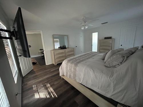 a bedroom with a bed and a flat screen tv at 5 Bedrooms, 4 Bathrooms, Pool, Gym, Sleeps 16 Leesburg Retreat!!!! in Leesburg