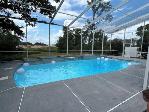 a swimming pool in a building with a glass ceiling at 5 Bedroom 4 Bathroom Pool Gym Leesburg Retreat in Leesburg