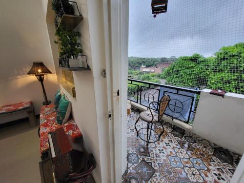 a room with a balcony with a view at Home Stay with Giriraj View I On Parikrama Marg I 5 mins to ISKCON & Daan Ghati in Govardhan