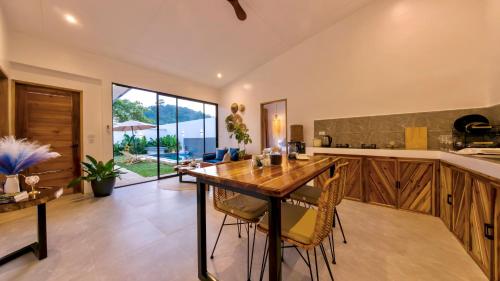 an open kitchen with a wooden table and chairs at Mamaya Rental Villas El Nido in El Nido Airport