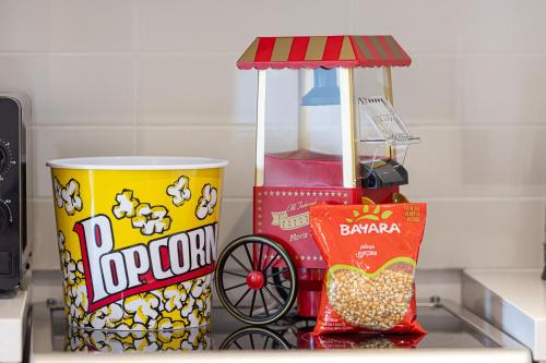 a counter top with snacks and a can of popcorn at DVH Luxe Retreats 1BR Yas Island by Ferrari World and Yas Mall in Yas Island