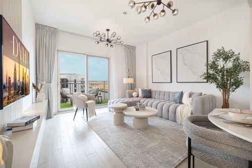 a living room with a couch and a table at DVH Luxe Retreats 1BR Yas Island by Ferrari World and Yas Mall in Yas Island