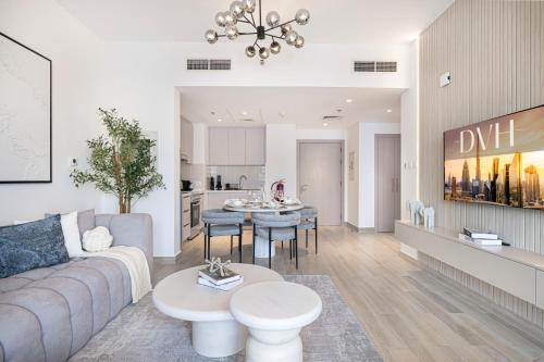 a living room with a couch and a table at DVH Luxe Retreats 1BR Yas Island by Ferrari World and Yas Mall in Yas Island
