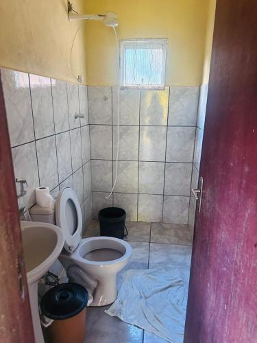ein Badezimmer mit Toilette und Waschbecken in der Unterkunft Sítio do Ademir in Jaboticatubas