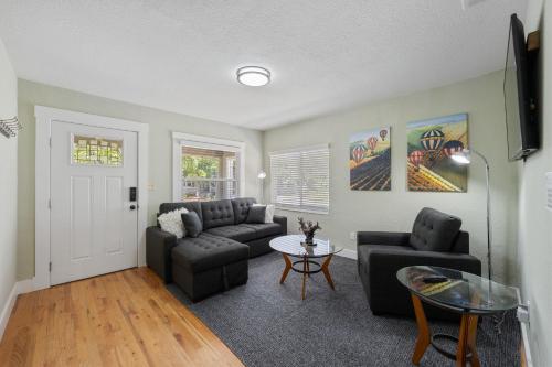 a living room with two couches and a table at Cozy Home 7 minutes Walk to UC Davis Sacramento in Sacramento