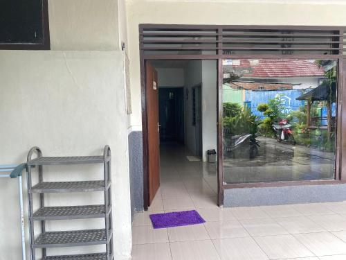 a door to a building with a staircase next to it at Neo Robiu & Ijen Tour in Banyuwangi