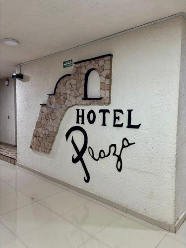 a hotel sign on a wall in a room at Hotel Plaza in Tepatitlán de Morelos