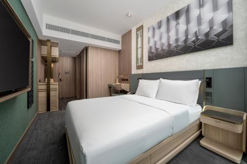 Motto by Hilton Hong Kong Sohoにあるベッド