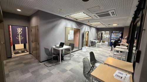 a room with tables and chairs in a store at Namba Ambers Hostel 6612 in Osaka