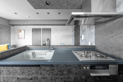 a kitchen with a sink and a counter top at J-star 901 in Sapporo