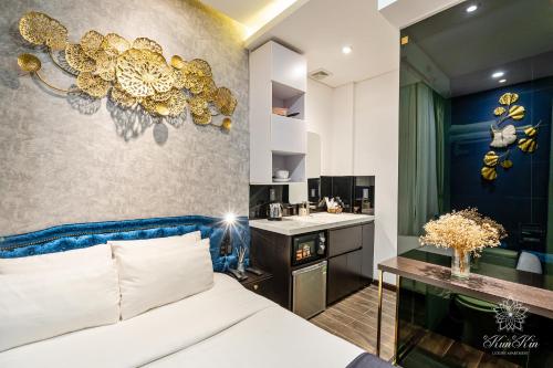 a bedroom with a bed and a bathroom with a sink at KunKin Luxury Hotel & Apartment in Ho Chi Minh City