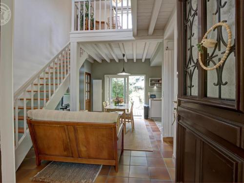 a home with a staircase and a living room at Maison cosy avec terrasse, jardin fleuri, et tout confort à Saint-Galmier - FR-1-496-292 in Saint-Galmier