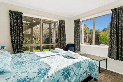 a bedroom with a large bed and a window at Mercy of Lake Taupo in Taupo